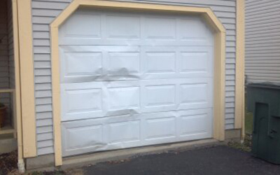 garage door damaged panel repair in Atlantis